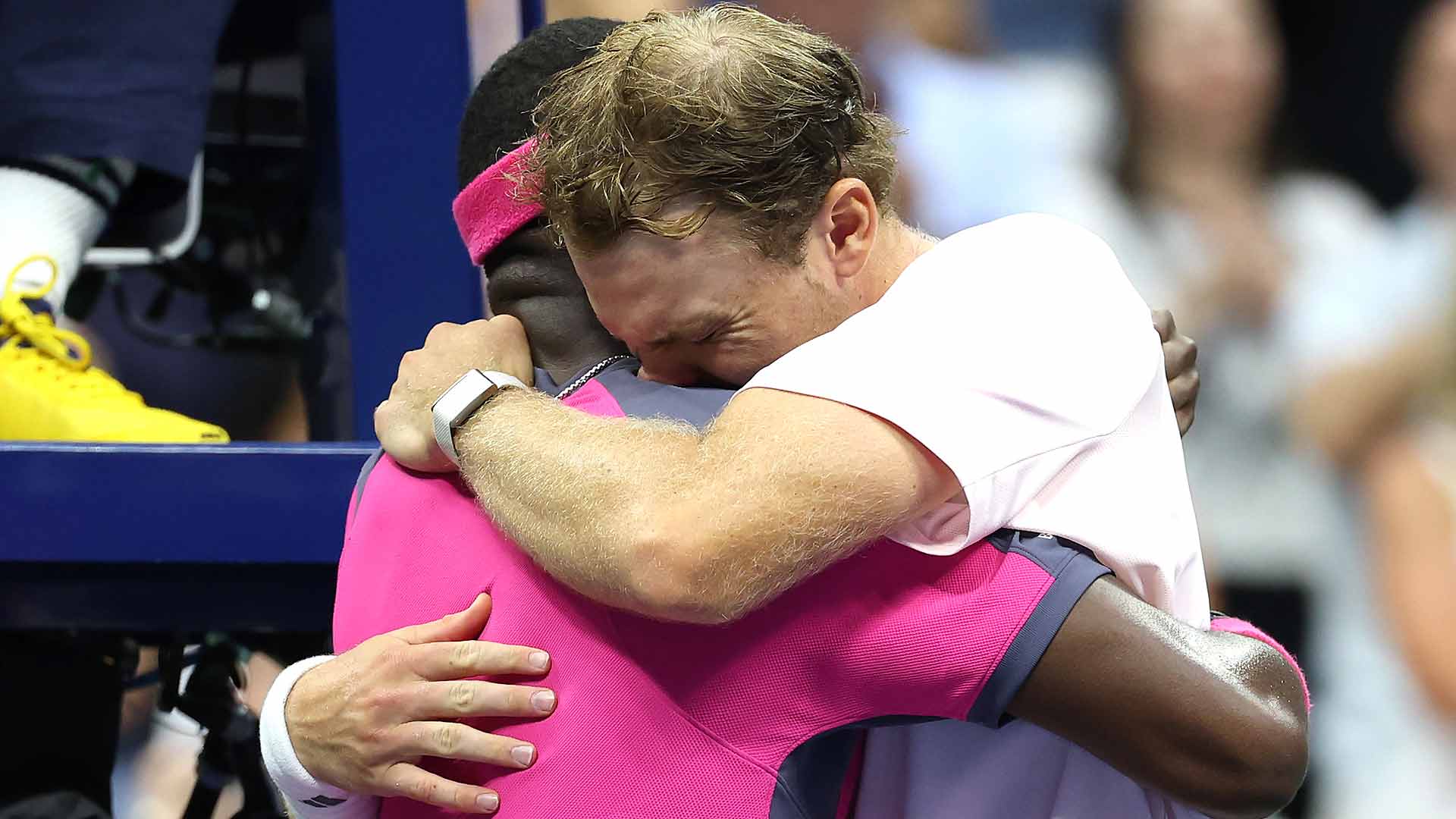 Frances Tiafoe and Alex Michelsen embrace after their five-set quarter-final at the US Open.